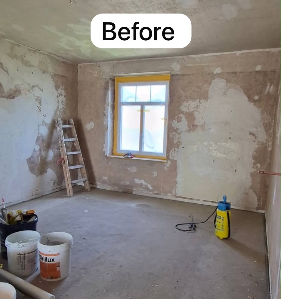 Bedroom before decorating — bare plaster walls, filled patches and an unfinished floor